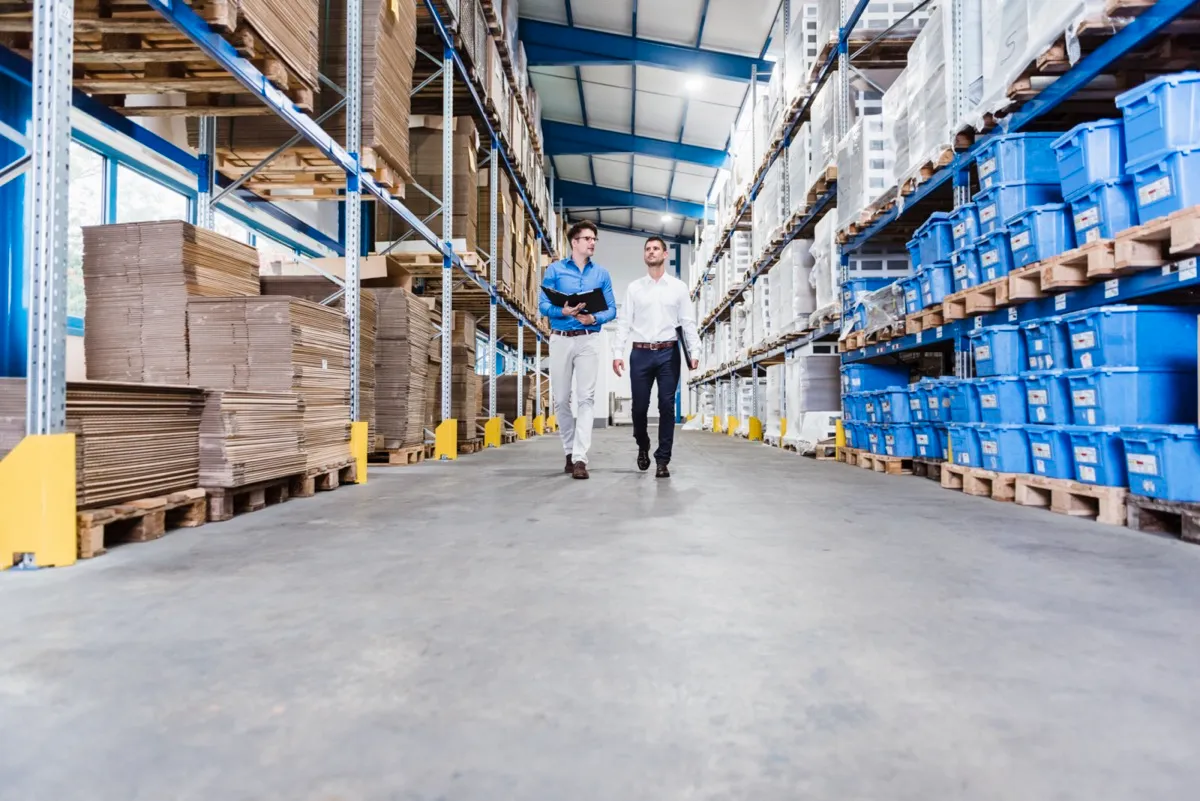 Supply chain consultants reviewing warehouse operations