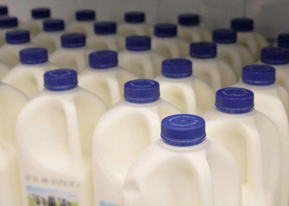 Milk bottles on supermarket display shelf